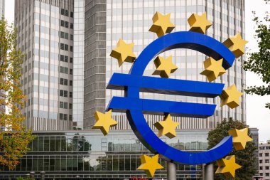 FRANKFURT - OCTOBER 4, 2013: The Euro Sign in Frankfurt, Germany. The sign is part of Eurotower which serves as the seat of the European Central Bank. clipart