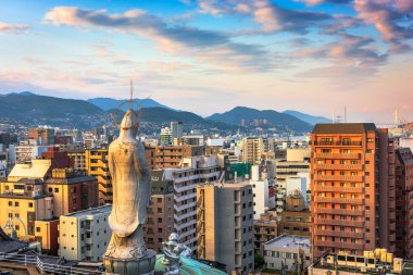 NAGASAKI, JAPAN - MARCH 26, 2017: The Nagsaki cityscape with Fukusaiji Temple at dusk. clipart