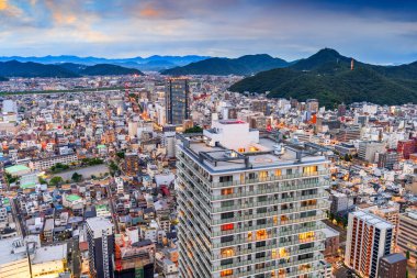 Gifu City, Gifu Prefecture, Japan cityscape from above with the mountains at dusk. clipart