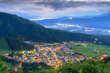 Nozawa Onsen, Nagano Prefecture, Japan from the mountains at dusk. clipart