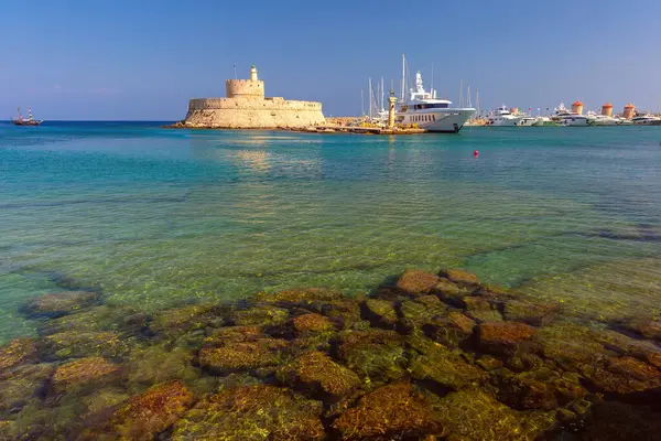 stock image St Nicholas Fortress in Rhodes, Greece with yachts and clear turquoise water