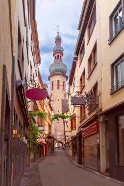 A narrow street in Cochem, Germany, leading to Saint Martin Church, framed by historic buildings clipart