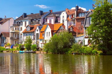 Colorful riverside houses along the Lahn River in Marburg, Germany, on a sunny summer day clipart