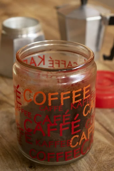 glass jar of powder coffee with written the coffee word