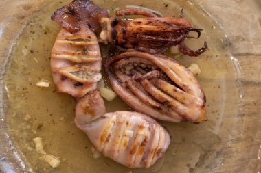 rosted squid seasoned with garlic oil and lemon