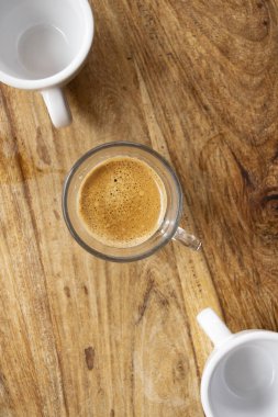 espresso glass cup with two white empty cup