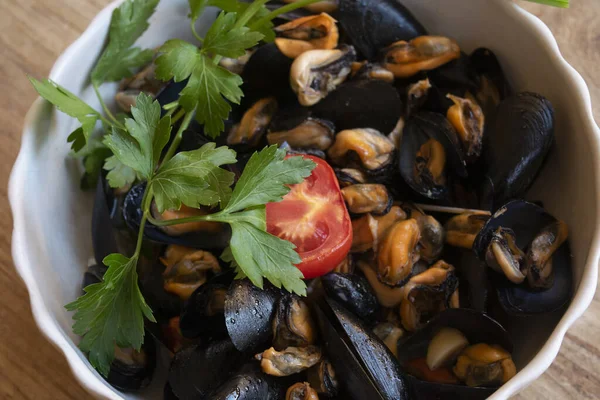 stock image bowl of peppered mussels with parsley and tomato