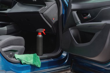 Arabanın içinde temizlik malzemeleri ve mikrofiber kumaş var.