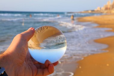 Beach vibes in Haifa, Israel. Glass ball reflection of Dado Beach in Haifa. clipart