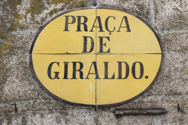 Evora architecture detail in Portugal. Street sign with square name: Praca de Giraldo.