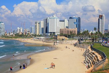 TEL AVIV, ISRAEL - NOVEMBER 2, 2022: People visit Alma Beach in Tel Aviv, Israel. Tel Aviv is the economic and technological center of Israel.