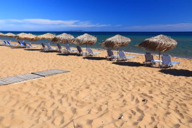 Gardenos Beach sunbeds in Corfu Island, Greece. Beach infrastructure on Greek island.