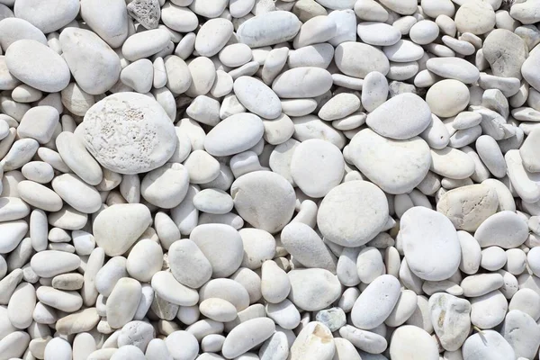 White zen stone beach texture in Corfu island, Greece. White stone background.