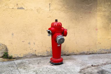 Fire hydrant in Perpignan, France. Red standpipe. Fire safety infrastructure.