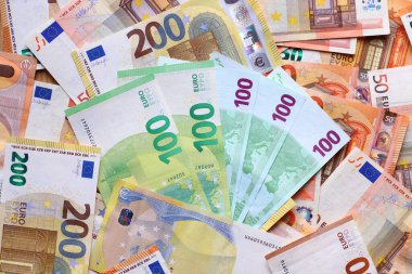 Euro currency banknotes background. European paper money backdrop with 50, 100 and 200 euros bills.