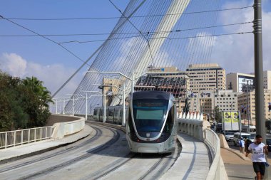 JERUSALEM, ISRAEL - OCTOBER 30, 2022: Jerusalem Light Rail public transportation electric tramway line crossing the Chords Bridge in Jerusalem, Israel.