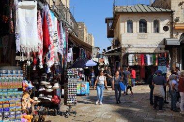 JERUSALEM, ISRAEL - OCTOBER 28, 2022: Tourists visit one of many souks (marketplaces) in Christian Quarter of Jerusalem, Israel. Jerusalem is a major tourism and pilgrimage destination in Israel.