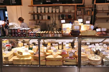 STOCKHOLM, SWEDEN - AUGUST 24, 2018: Cheese shop at Ostermalm's Market Hall (Ostermalms Saluhall) in Stockholm. It is a food marketplace focusing on meat, fish and gourmet food.