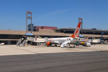 CURITIBA, BRAZIL - OCTOBER 9, 2014: Workers handle Gol Airline Boeing 737-800 at Curitiba Airport, Brazil. Gol is the 2nd largest Brazilian airline.