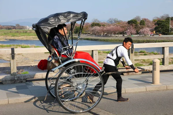 stock image KYOTO, JAPAN - APRIL 17, 2012: Visitors ride a rickshaw in Arashiyama, Kyoto, Japan. Arashiyama is a nationally-designated Place of Scenic Beauty and Historic Site.