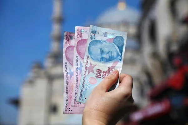 Turkish lira. Currency of Turkey - hand holding used banknotes. Turkish money.