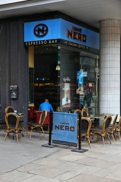 Stock image LONDON, UK - JULY 9, 2016: People visit Caffe Nero in London. There are about 1,500 coffee shops in London.