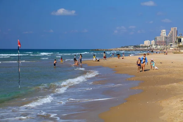 HAIFA, ISRAEL - NOVEMBER 1, 2022: People visit sandy Dado Beach in Haifa, Israel. Haifa is Israel's 3rd largest city.