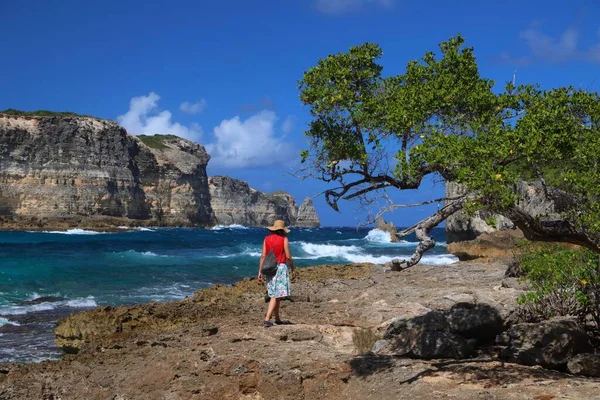 stock image GUADELOUPE, FRANCE - DECEMBER 7, 2019: Woman tourist visits cliffs of Porte d'Enfer (Hell's Gate) in Guadeloupe.