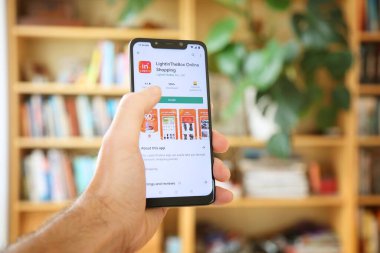 WARsaw, POLAND - 29 Ocak 2021: Android OS, Xiaomi akıllı telefon üzerinden LightInTheBox çevrimiçi alışveriş mobil uygulaması yükleyen kullanıcı.