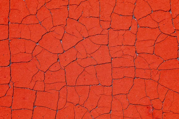 Kırmızı, pasaklı arka plan. Soyulmuş boyanın geçmişe dönük dokusu. Yıpranmış kırık boya grunge arka plan yüzeyi.