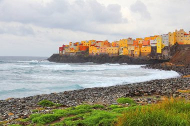 Gran Canaria - colorful houses and Atlantic coast. Rainy weather in El Roque. clipart