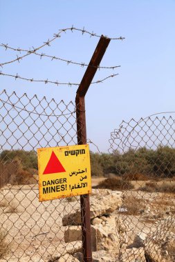 Danger mines! Warning in three languages (Hebrew, Arabic and English) about landmines in Palestine (officially part of Israel).