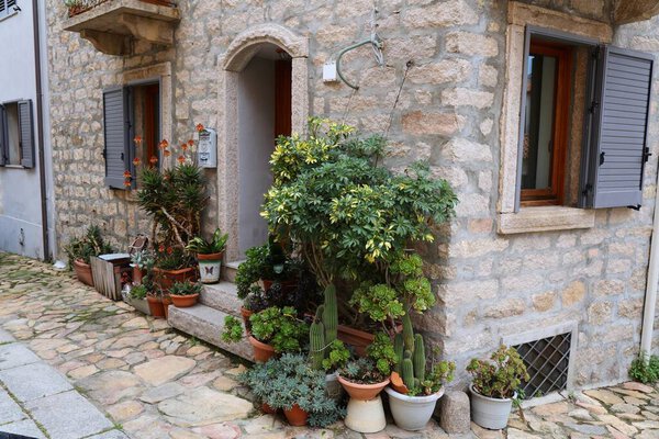 Aggius small town in Sardinia, Italy. Italian town street sidewalk cozy flowerpot garden.