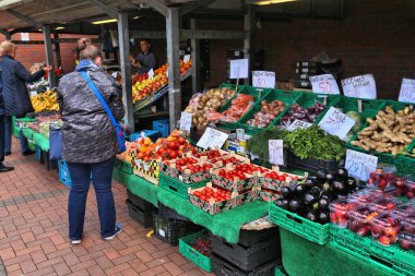 LEEDS, UK - JULY 11, 2016: People visit Leeds City Markets outdoor stalls in the UK.