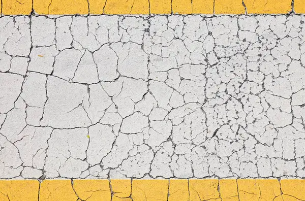 Cracked paint background. Yellow frame border and white weathered surface. Blank copyspace grunge banner.