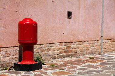 Fire hydrant in Venice, Italy. Fire safety infrastructure - red standpipe.