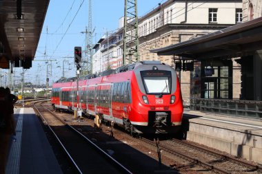 ERLANGEN, GERMANY - MAY 6, 2018: Bombardier passenger train of Deutsche Bahn (German Railways) at Erlangen train station in Germany. clipart