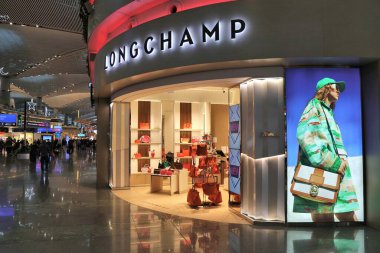 ISTANBUL, TURKEY - APRIL 11, 2023: Longchamp luxurry handbag brand duty free shop at Istanbul Airport, one of busiest airports in the world. clipart