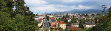 Klagenfurt city panorama in Austria. Karawanks Alps range in background. clipart