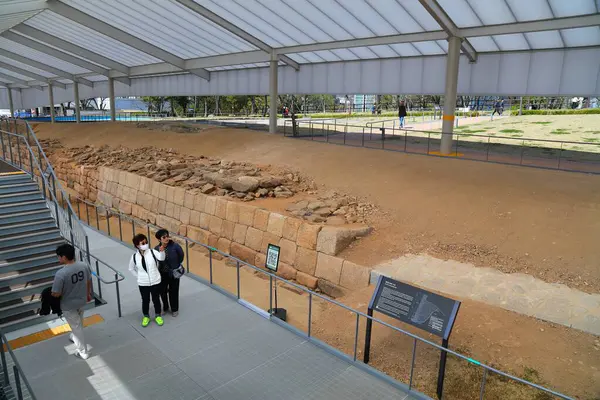 stock image SEOUL, SOUTH KOREA - APRIL 8, 2023: People visit archeological excavation area of historic Seoul City Walls in Namsan, Seoul.