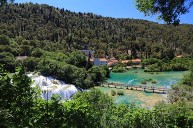 Krka şelaleleri ve turist yolu köprüsü. Hırvatistan 'daki Krka Ulusal Parkı. Hırvatistan 'ın manzarası.