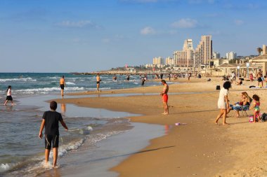 HAIFA, ISRAEL - NOVEMBER 1, 2022: People visit sandy Dado Beach in Haifa, Israel. Haifa is Israel's 3rd largest city.