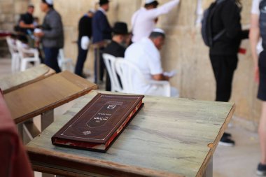 JERUSALEM, ISRAEL - OCTOBER 28, 2022: Book of Psalms with the Western Wall (or Wailing Wall) in Jerusalem Old City. It is part of Jerusalem's UNESCO World Heritage Site. clipart