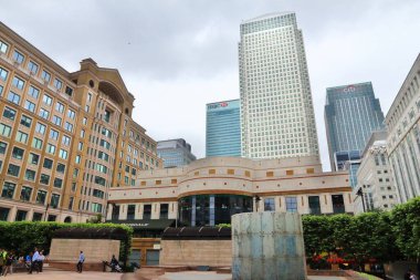 LONDON, UK - JULY 8, 2016: People visit Cabot Square in Canary Wharf modern area in London, UK. Canary Wharf is London's second financial centre. clipart