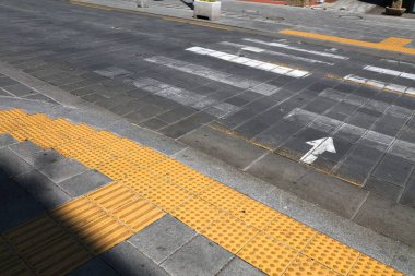 Tactile paving (tenji blocks) by the pedestrian crossing in Seoul, South Korea. Vision impaired disability infrastructure. clipart