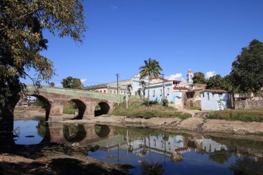 Sancti Spiritus, Cuba - townscape with River Yayabo bridge. clipart