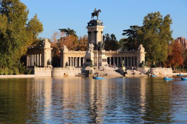 Madrid landmark in Spain. Monument to Alfonso XII in Retiro Park. Sunset light. clipart