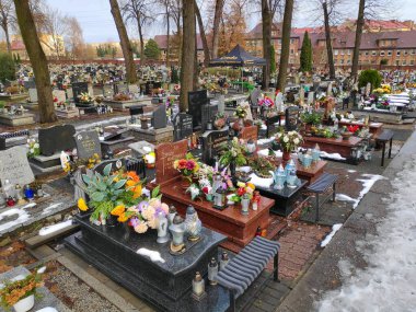 SIEMIANOWICE SLASKIE, POLAND - DECEMBER 12, 2023: Grave decorations at a cemetery in Siemianowice Slaskie, Poland. clipart