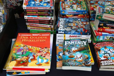 KLAGENFURT, AUSTRIA - 12 Ağustos 2022: Donald Duck Disney çizgi romanları ve Almanca Asteriks çizgi romanları Klagenfurt, Avusturya 'daki Altstadtsauber bit pazarında.