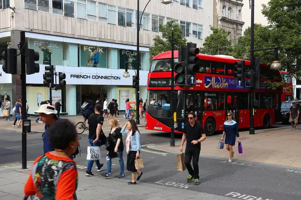 stock image LONDON, UK - JULY 7, 2016: People ride New Routemaster bus in Oxford Street, London. The hybrid diesel-electric bus is a new, modern version of iconic double decker.